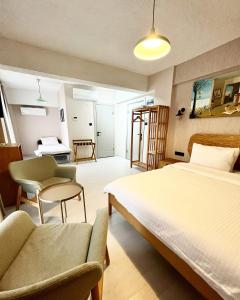 a bedroom with a bed and a chair and a desk at Mare House Boutique Hotel in Bursa