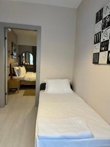 a white bedroom with a bed and a mirror at Mare House Boutique Hotel in Bursa