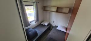 a small room with a bench and a window at Camping Le Pré Cathare in Lavelanet +33 photos