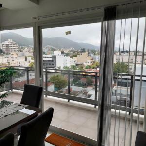 a room with a large window with a view of a city at Edificio Leonardo 6to piso in Villa Carlos Paz
