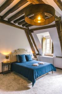 Postel nebo postele na pokoji v ubytování Maison d'hôtes le Prieuré du Preux