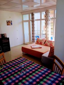 a living room with a couch and a table at VIP apart SVETLANA in Ravda