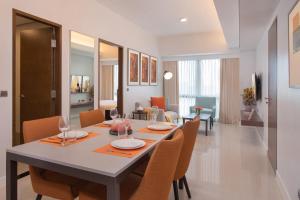 a dining room with a table and chairs at Citadines Benavidez Makati in Manila