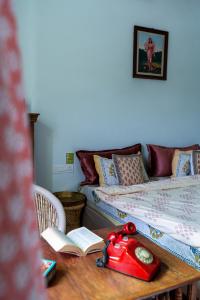 una habitación con 2 camas y una mesa con un libro en Kol Pol Mohalla Boutique Stay, en Udaipur