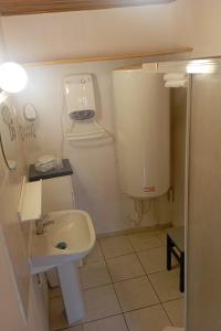 a small bathroom with a sink and a toilet at Appartement entier, La Chacuniere in Saint-Amant-Tallende