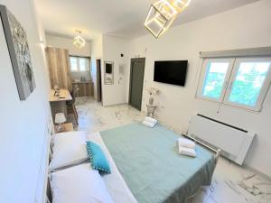 een slaapkamer met een groot groen bed en een televisie bij Corfu Airport Sweet Studio in Ágios Rókkos