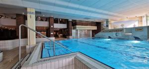 a large swimming pool in a large building at Pools, Sauna und Balkon mit Panoramablick in Sankt Englmar