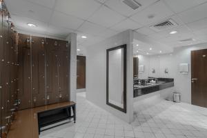 迪拜Icon Delux Hotel Apartments Al Barsha - Formerly Abidos的更衣室设有水槽和镜子