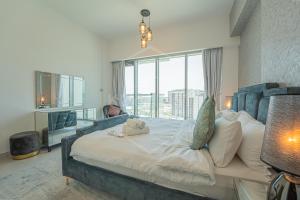 a bedroom with a large bed with a large window at KeyHost - Large 2BR Apartment in Dubai Science Park - Mont Rose - K860 in Dubai