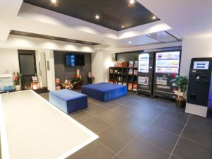 a room with two blue stools in a store at HOTEL LiVEMAX Tokyo-Otsuka Ekimae in Tokyo