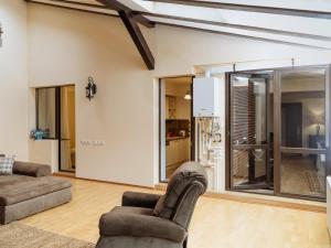 a living room with two chairs and a couch at Constellation Loft Colina Marei with fireplace, xBox & baby crib in Sinaia