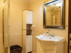 a bathroom with a sink and a mirror at Constellation Loft Colina Marei with fireplace, xBox & baby crib in Sinaia