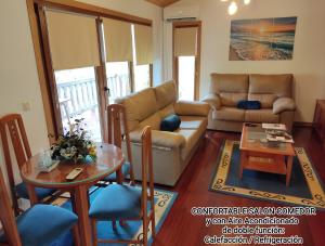 a living room with a couch and a table at Eido da Consaca in Ponteareas