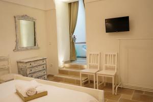a bedroom with a bed and a mirror and a television at Pietra d' Ostuni in Ostuni