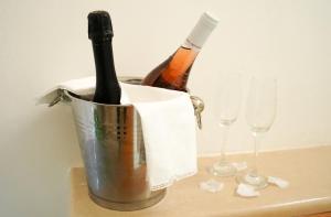 two bottles of champagne in a bucket next to two glasses at Pietra d' Ostuni in Ostuni