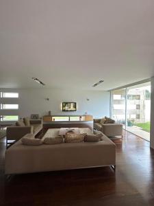 a bedroom with a large bed and a couch at Moradia Lux RR com piscina in Penafiel
