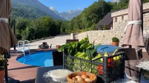 a patio with a pool and a basket of vegetables at Josanica Bed&Breakfast in Konjic