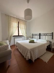 En eller flere senge i et værelse på Casa Pruno Rosso