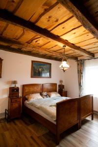 a bedroom with a large bed in a room with wooden ceilings at KONAK in Pleternica