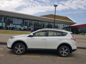 a white car parked in a parking lot in front of a building at Recalls in Samtredia