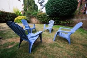 three blue and white chairs sitting in the grass at Solent Court in Portsmouth