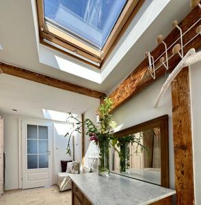 a skylight in a bathroom with a vanity and a mirror at Sopot Apartment 54 in Sopot