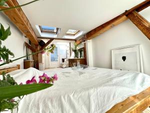 a large white bed in a room with skylights at Sopot Apartment 54 in Sopot