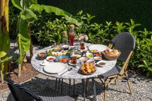 a table with food on top of it at Villa Lui Hotel Alaçatı in Ilıca