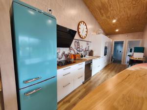 eine Küche mit einem blauen Kühlschrank in einem Zimmer in der Unterkunft Vitamin Sea Beach House in Riverton