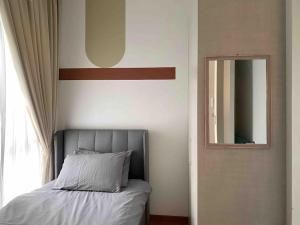 a bedroom with a bed and a mirror at To Come Again Abode, IOI Resort City, Putrajaya in Serdang