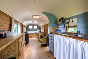 a kitchen with a counter and a sink in a room at Les insolites de la Ferme de Froidefontaine in Havelange