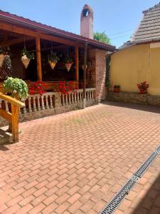 een bakstenen patio met potplanten en een gebouw bij Casa Ramona in Turda