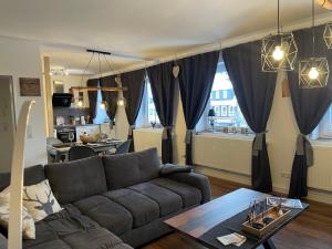a living room with a couch and a table at Harzstübl25 in Sankt Andreasberg
