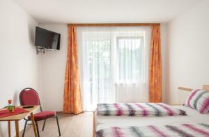 una camera d'albergo con letto e finestra di Bed & Breakfast Eckwirt a Sankt Kanzian