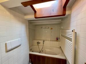 a bathroom with a bath tub and a sink at Due passi dal centro in Col