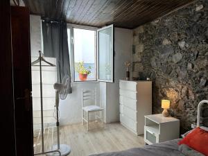 a bedroom with a bed and a window at Casa Álamo Agaete in Agaete