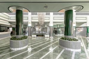 a lobby with green columns in a building at Club Paraiso 1306 in Playa Paraiso +52 photos