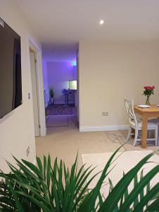 a living room with a table and a dining room at Barchester House Apartments in Salisbury