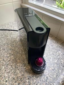 a black espresso machine sitting on a counter at Zandrijk in Egmond aan den Hoef