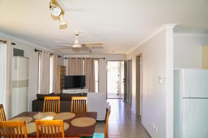 a kitchen and living room with a table and chairs at COZY 2 BEDROOM HOUSE /MELBOURNE in Werribee