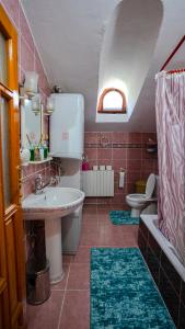 a bathroom with a sink and a tub and a toilet at kılıçbey villa esiroğlu in Trabzon