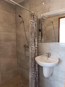 a bathroom with a sink and a shower at Pokoje Gościnne Heland in Jastrzębia Góra +34 photos
