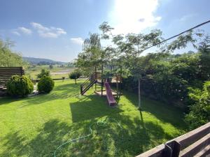 a playground in a yard with a slide at Precioso apartamento con jardín y piscina in Oruña