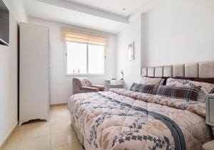 a bedroom with a large bed and a window at Splendide Appartement avec Piscine à Agadir in Agadir +18 photos