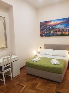 a white bedroom with a bed and a desk at GISELLE in Naples