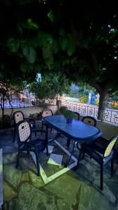a table and chairs with a blue table and chairs at Kali’s casa in Karavomylos