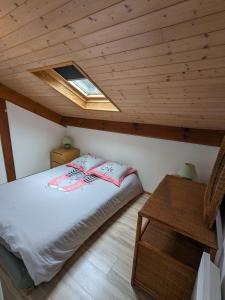 a bedroom with a bed and a skylight at Village Océlandes in Saint-Julien-en-Born