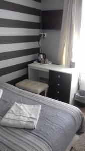 a bedroom with a bed and a table and a desk at Elmfield in Blackpool