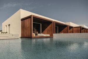 a building with a pool of water in front of it at Meraviglia Slow Living in Preveza