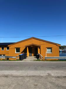 a large orange building with the door open at Modern apartment with an amazing seaview in Ballstad